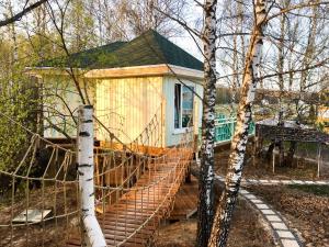 a house with a net fence in front of it at House on the Tree in Petrovo