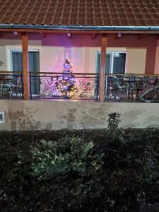 a christmas tree on the balcony of a house at Pensiunea Dan-Ge-La in Sălaşu de Sus