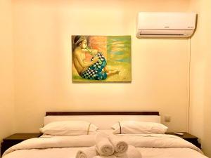a bedroom with a painting of a woman playing a trumpet at Sab 9 - Great View Over Hassan Mosque. Luxurious 3 Bedrooms & 2,5 Bathrooms in Casablanca