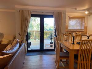 a living room with a couch and a table and a dining room at Immaculate 3 bed lodge in Blairgowrie in Blairgowrie