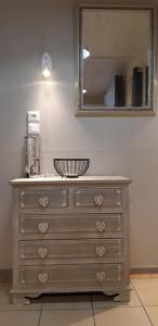 a dresser with a mirror in a room at Gîte le chalet vert , prêt de raquettes in Frambouhans