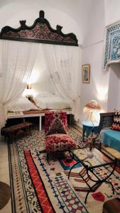 a living room with a bed and a couch at Dar R'Bat in Nabeul
