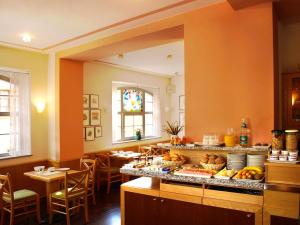 a kitchen with a table with food on it at Hotel Dom-Eck in Bautzen