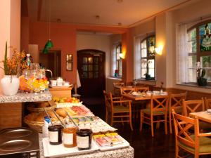 a restaurant with a table with food on it at Hotel Dom-Eck in Bautzen