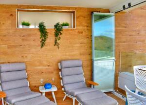 Zimmer mit 2 Stühlen und einem Fenster mit Pflanzen in der Unterkunft SUNNY BEACH APARTMENT IN CALACEITE in Torrox Costa
