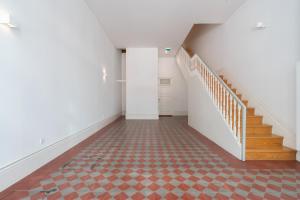 an empty hallway with a staircase and a tile floor at Habitatio - Aliados by LuxiStay in Porto