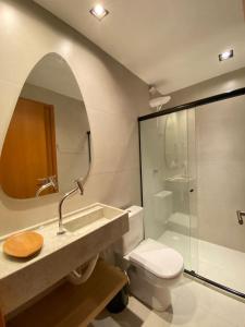 a bathroom with a sink and a toilet and a mirror at PATACHO VILLE - Rota Ecológica dos MILAGRES in Pôrto de Pedras