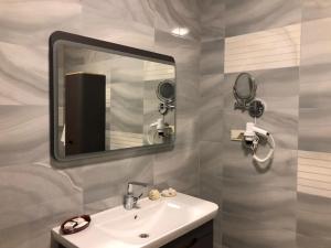 a bathroom with a sink and a mirror at Blue Pier Hotel in Kocaeli
