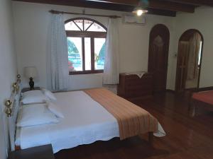 En eller flere senge i et værelse på Estância Timbaúva