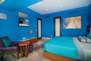 a blue bedroom with a bed and a chair at THE BLUE APARTMENT in Puerto Vallarta