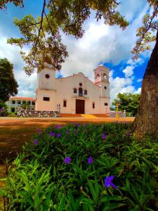 a building with purple flowers in front of it at Las Catalinas Anton Panama in Antón