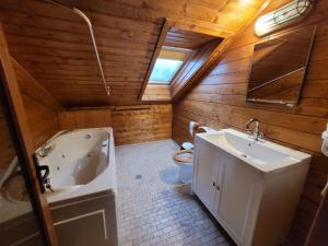 a bathroom with a tub and a sink and a toilet at Vila Caluco in Predeal