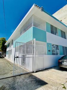 ein weißes und blaues Gebäude mit einem Tor in der Unterkunft Star of the Olympus in San Juan