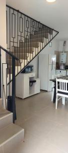 a living room with a staircase in a kitchen at El canto de los pajaros in Villa Carlos Paz +64 photos