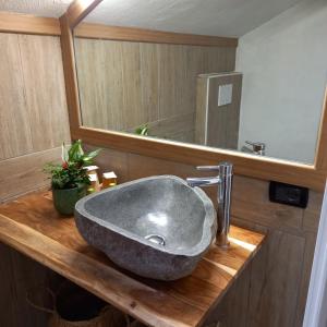 a bathroom with a sink and a large mirror at mansarda roulette in Saint Vincent