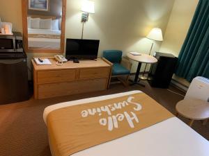 a hotel room with a bed and a desk at Days Inn by Wyndham Ocean Shores in Ocean Shores
