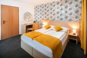 a bedroom with a large bed with yellow sheets at Chata Belez in Dolný Kubín