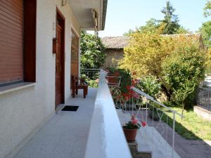 a balcony of a house with flowers on it at Cristina B&B in Sassoferrato