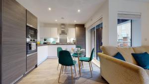 a kitchen and living room with a table and chairs at Luxury 2 Bed Apartment with Parking near London in Swanscombe