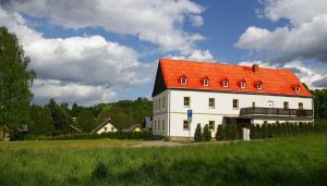 a large white building with an orange roof at Apartmány Růžová in Růžová