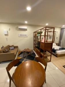 a living room with a table and a couch at kuantan staycationtimurbay in Kuantan +26 photos
