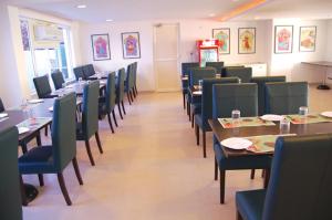 a dining room with tables and chairs and tablesktop at Way Inns in Hyderabad
