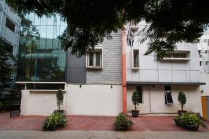a building with two potted plants in front of it at Way Inns in Hyderabad