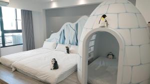 a childs bedroom with an igloo bed with penguins on it at 胖蝸牛親子民宿 in Anping