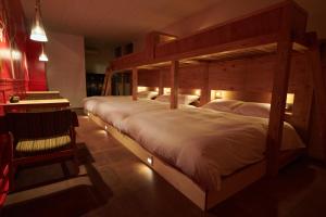 a bedroom with a large wooden bed in a room at Ryokan Plum in Odawara