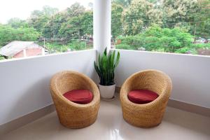 dos sillas de mimbre sentadas frente a una ventana en JOY'S BNB, en Imphal