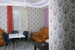 a living room with a couch and a table at Hotel Kambuz in Sevan