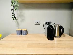 a tea kettle on a wooden counter top at Studio F13 in Topliţa