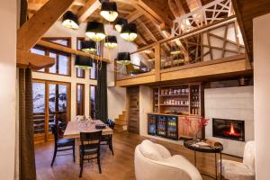 a dining room with a table and chairs and a fireplace at Wanderful Life Les Arcs refuge haut de gamme in Arc 1600