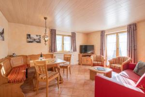 a living room with a couch and a table at Ferienhotel Sonnenheim in Oberstdorf