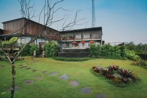 a house with a garden in front of it at Pramana Zahill Kintamani in Kintamani