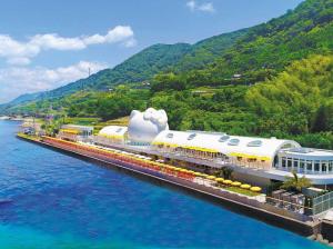 a train on a bridge over a body of water at Awaji Central Inn Kuruma713 in Awaji