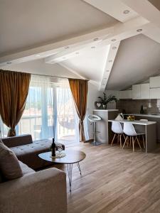 a living room with a couch and a table at Mavalux apartments in Tivat
