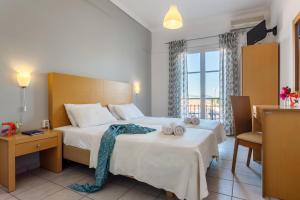 A bed or beds in a room at Argo Pension