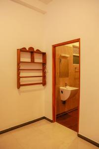 a bathroom with a sink and a mirror at JAMI River Side Hotel & Yala Safari Place in Tissamaharama