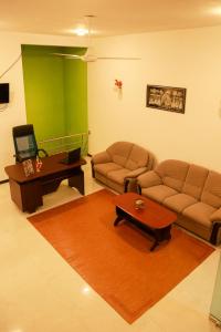 a living room with a couch and a table at JAMI River Side Hotel & Yala Safari Place in Tissamaharama