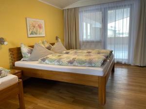 a large bed in a room with a window at Appartement Fischer in Sankt Johann in Tirol