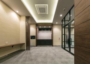 an empty hallway with a door and a building at Remington Hotel in Akashi