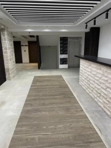 a large empty room with a stone wall at Apart1305zoned2 in Kopaonik