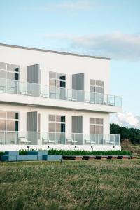 a white building with balconies on the side of it at Sunlight On the Peninsula in Eluan