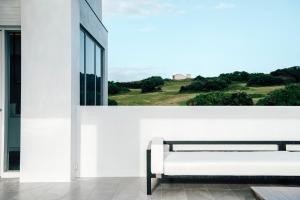 a white room with a bench and a window at Sunlight On the Peninsula in Eluan