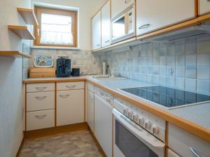 a small kitchen with a sink and a stove at Appartement Dorfblick in Bad Kleinkirchheim