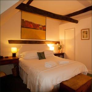 a bedroom with a large white bed in a room at The Old Stables B&B in Winslow