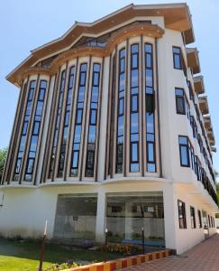 a large building with a lot of windows at Hotel Zoon Dabb Srinagar airport kashmir in Srinagar