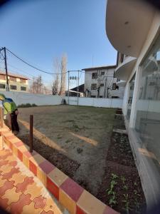 a person standing in a yard next to a building at Hotel Zoon Dabb Srinagar airport kashmir in Srinagar