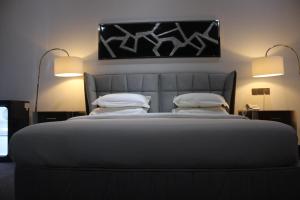a large bed in a room with two lamps at MUSE Boutique Hotel in Enugu